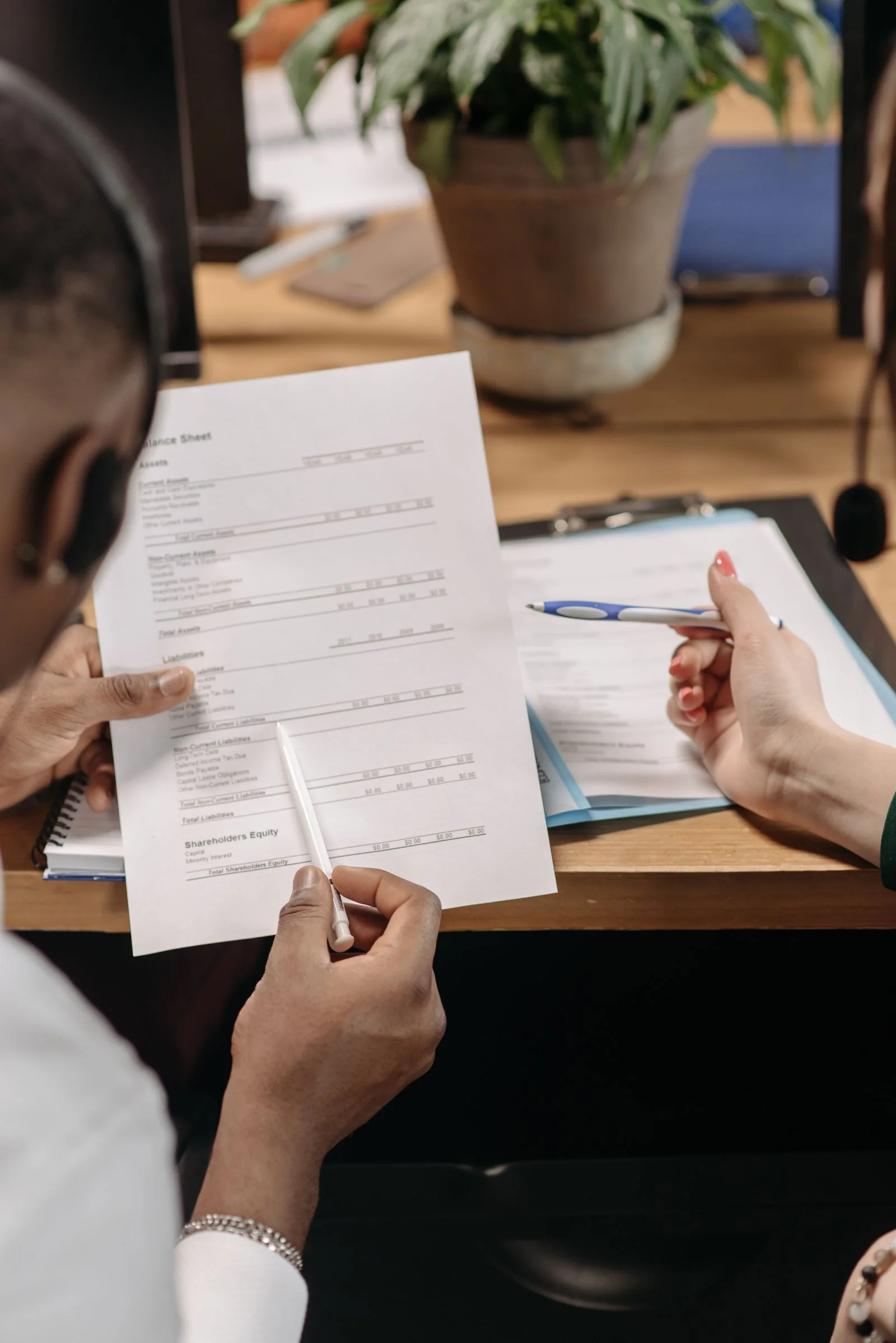 Professional reviewing business documentation with an entrepreneur